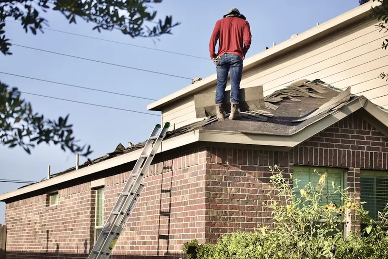 Professional roofer working on a residential roof in Old Hollow Estates